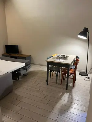 a room with a table and chairs and a lamp at GA Holidays Home2 in Rome
