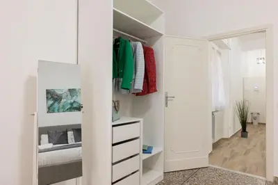 a bedroom with a white closet with a bed at Central Modern Apartment - Trastevere & Vaticano in Rome