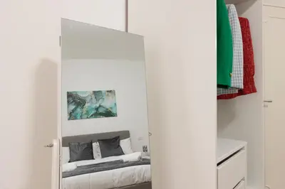 a bedroom with a mirror with a bed in it at Central Modern Apartment - Trastevere & Vaticano in Rome