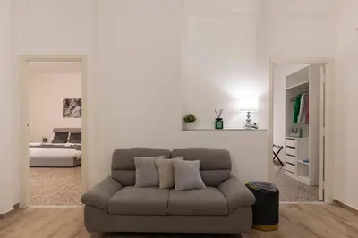 a living room with a couch and a bedroom at Central Modern Apartment - Trastevere & Vaticano in Rome