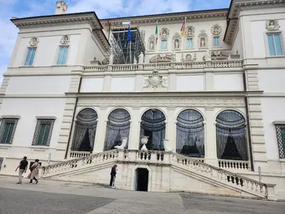 people walking in front of a white building at Charming apartment near Villa Borghese in Rome