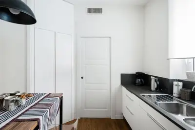 a kitchen with a sink and a white door at Charming apartment near Villa Borghese in Rome