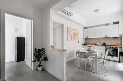 a kitchen and dining room with a table and chairs at Porta Furba Apartment in Rome