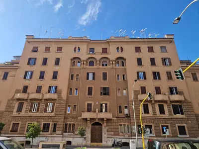 a large brick building with birds on the top of it at Casa Kathy Rome in Rome
