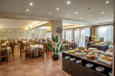 a restaurant with tables and chairs and food on display at Hotel Marc'Aurelio in Rome
