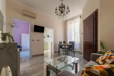 a living room with a couch and a table at GuestHost - Sweety Apartment near MM Ottaviano in Rome