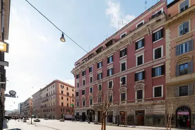 a large brick building on a city street at GuestHost - Sweety Apartment near MM Ottaviano in Rome