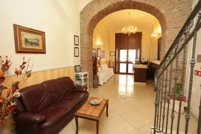 a living room with a couch and a staircase at Hotel Hollywood in Rome