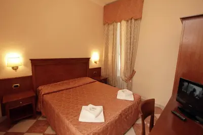 a hotel room with a bed and a television at Hotel Hollywood in Rome