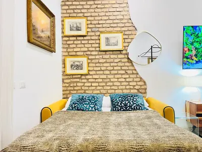 a bedroom with a bed and a brick wall at Colosseum-Apartments in Rome