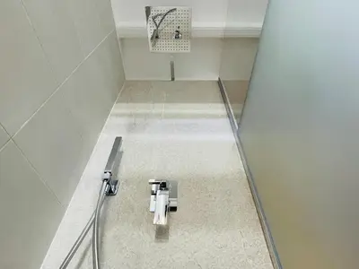 a bathroom with a walk in shower with a door at Colosseum-Apartments in Rome