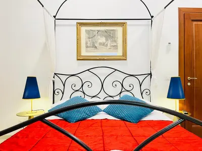 a bedroom with a black and red bed with blue pillows at Colosseum-Apartments in Rome