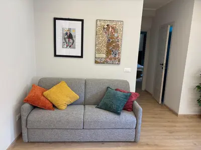 a couch with colorful pillows in a living room at Suite dell'Arte - Metro linea A in Rome