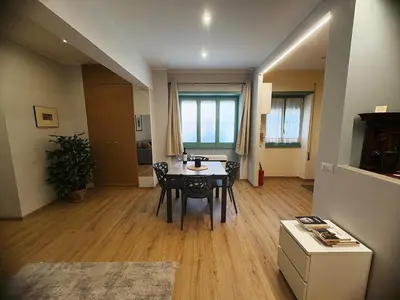 a dining room with a table and chairs in a room at Suite dell'Arte - Metro linea A in Rome