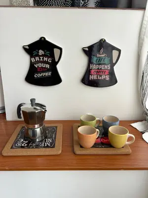 a table with cups and a tea pot and a shirt at Along the Tiber Apartment in Rome