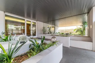 a lobby of a building with plants at Along the Tiber Apartment in Rome