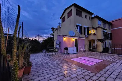 a house with a brick patio in front of a building at Domus Monamì Dreams & Terrace in Trastevere in Rome