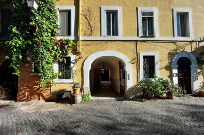 an entrance to a building with a brick courtyard at Domus Monamì Dreams & Terrace in Trastevere in Rome