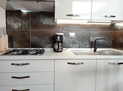a kitchen with white cabinets and a sink at Domus Monamì Dreams & Terrace in Trastevere in Rome