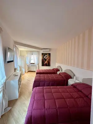 a large bedroom with two beds with red blankets at Bella Trastevere in Rome