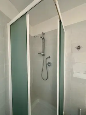 a shower with a glass door in a bathroom at Bella Trastevere in Rome