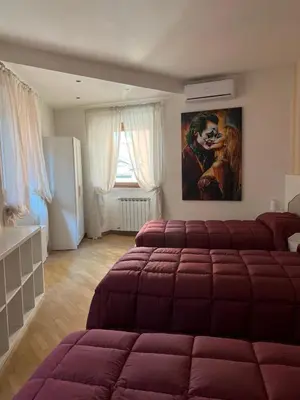 a bedroom with a bed and a painting on the wall at Bella Trastevere in Rome