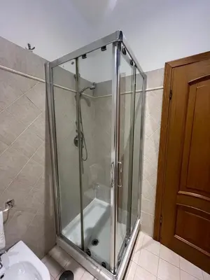 a glass shower in a bathroom with a sink at Bella Trastevere in Rome