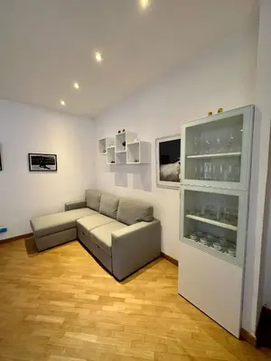 a living room with a couch and a glass cabinet at Bella Trastevere in Rome