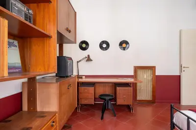 a kitchen with a desk and a chair in a room at Maroon Flat Colosseo, 800 mt from Amphitheater in Rome