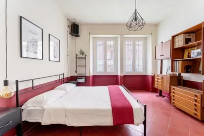 a bedroom with a large bed in a room at Maroon Flat Colosseo, 800 mt from Amphitheater in Rome