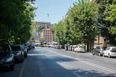a street with cars parked on the side of the road at Roma Vatican-Ottaviano's Homies in Rome