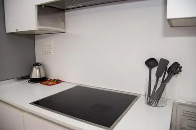 a kitchen counter with a sink and utensils at Roma Vatican-Ottaviano's Homies in Rome