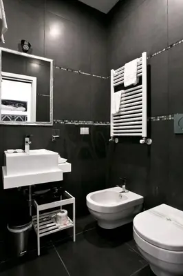 a bathroom with a white sink and a toilet at Rome Key Luxury House in Rome