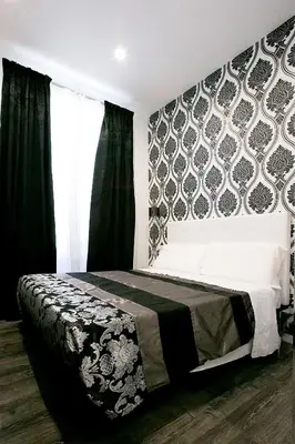 a bedroom with a bed with a black and white patterned wall at Rome Key Luxury House in Rome
