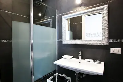 a bathroom with a sink and a shower at Rome Key Luxury House in Rome