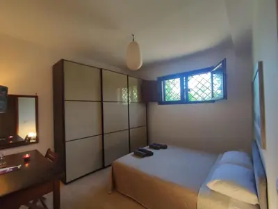 a bedroom with a bed and a dresser and a window at Parrot Room - Camera a Roma con bagno privato in Rome