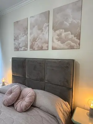 a bedroom with three pictures of clouds on the wall at Antica Dimora Luxury in Rome