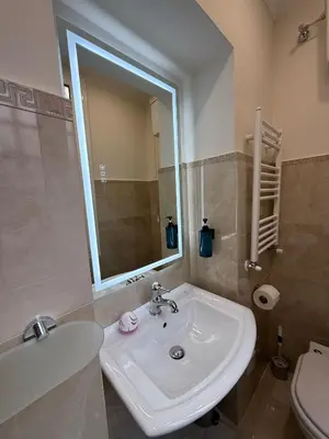 a bathroom with a sink and a toilet and a mirror at Antica Dimora Luxury in Rome