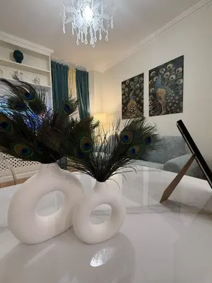 a white vase with peacock feathers in a living room at Antica Dimora Luxury in Rome