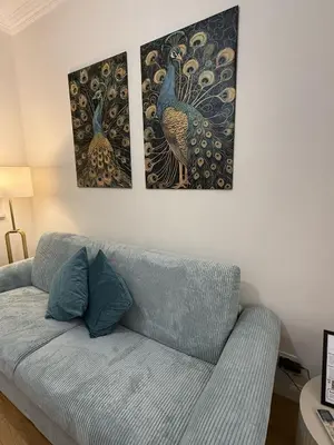 three pictures hanging on a wall above a couch at Antica Dimora Luxury in Rome