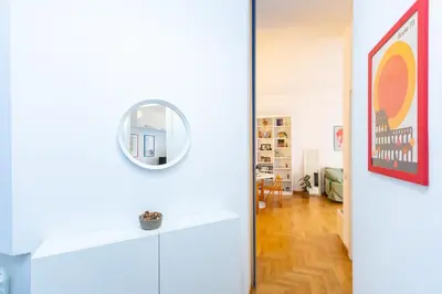a white room with a mirror on the wall at Pop Studio Trastevere in Rome