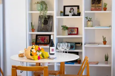 a table with two chairs and a bottle of wine at Pop Studio Trastevere in Rome