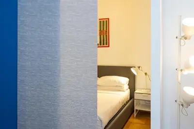 a small bedroom with a bed and a table at Pop Studio Trastevere in Rome