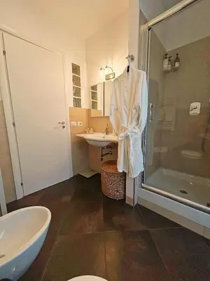 a bathroom with a shower and a sink and a tub at Roman Interlude in Rome