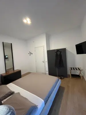 a bedroom with a large bed and a mirror at Roman Interlude in Rome