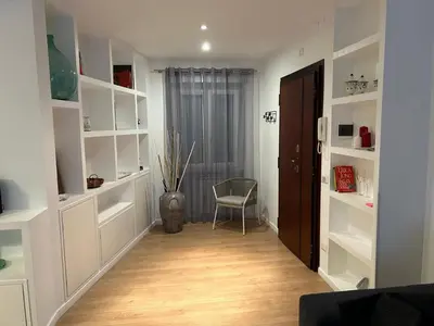 a hallway with white shelves and a chair in a room at Roman Interlude in Rome