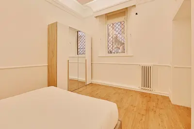 a white room with a bed and a window at Casa di borgo in Rome
