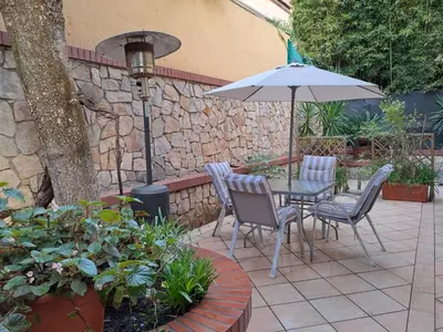 a patio with a table and chairs and an umbrella at Romeo&Giulietta in Rome