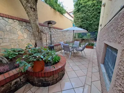 a patio with a table and chairs and an umbrella at Romeo&Giulietta in Rome