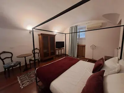 a bedroom with a large bed and a table and a desk at Romeo&Giulietta in Rome